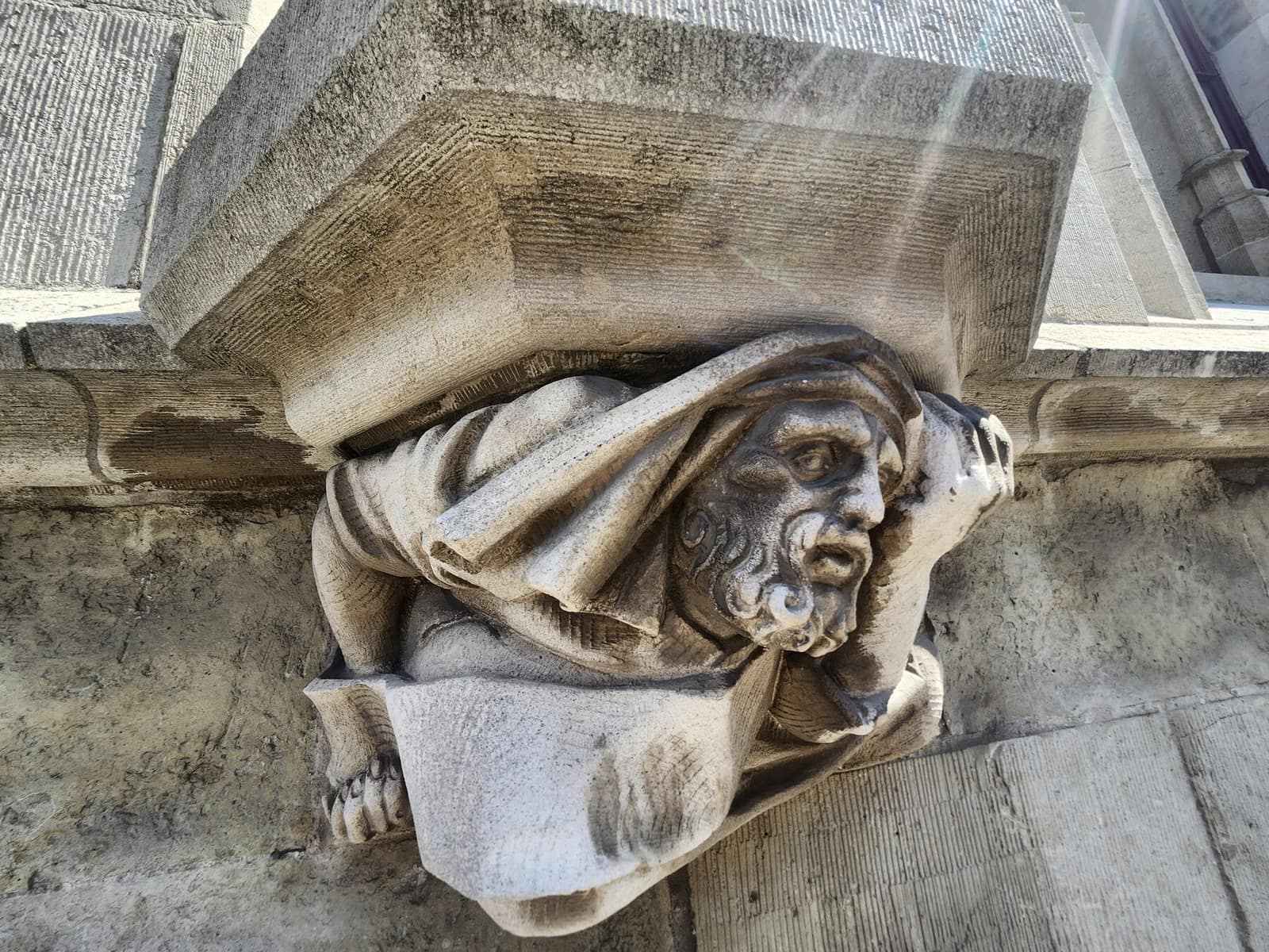 Carved stone corbel figure